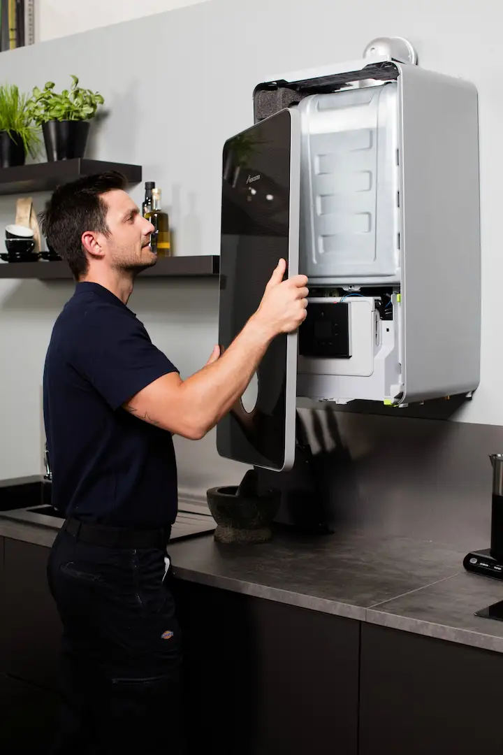 Plumber installing a Worcester bosch gas boiler