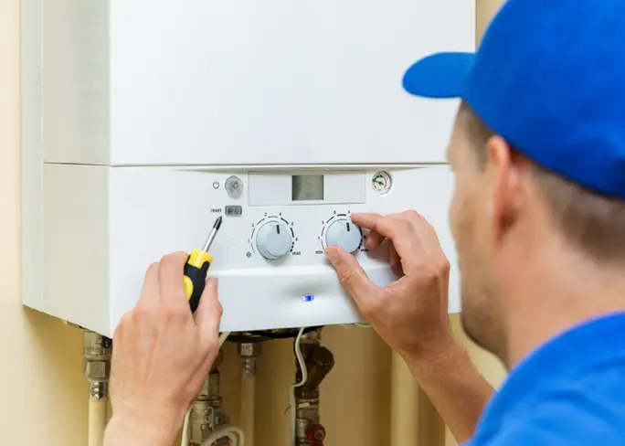 Technician installing gas boiler