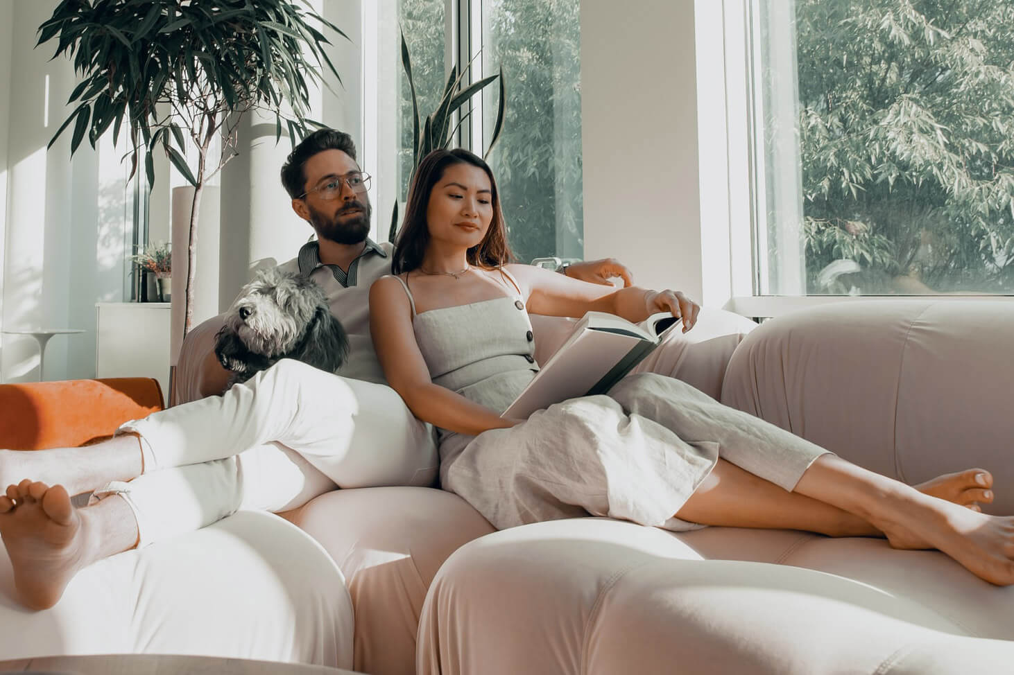 Couple reading book in a cozy hliving room